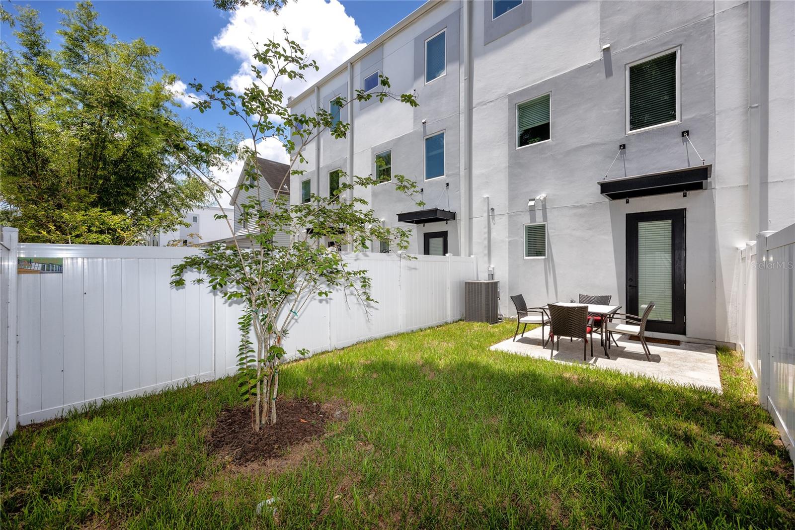 Large maintenance free fenced in patio.