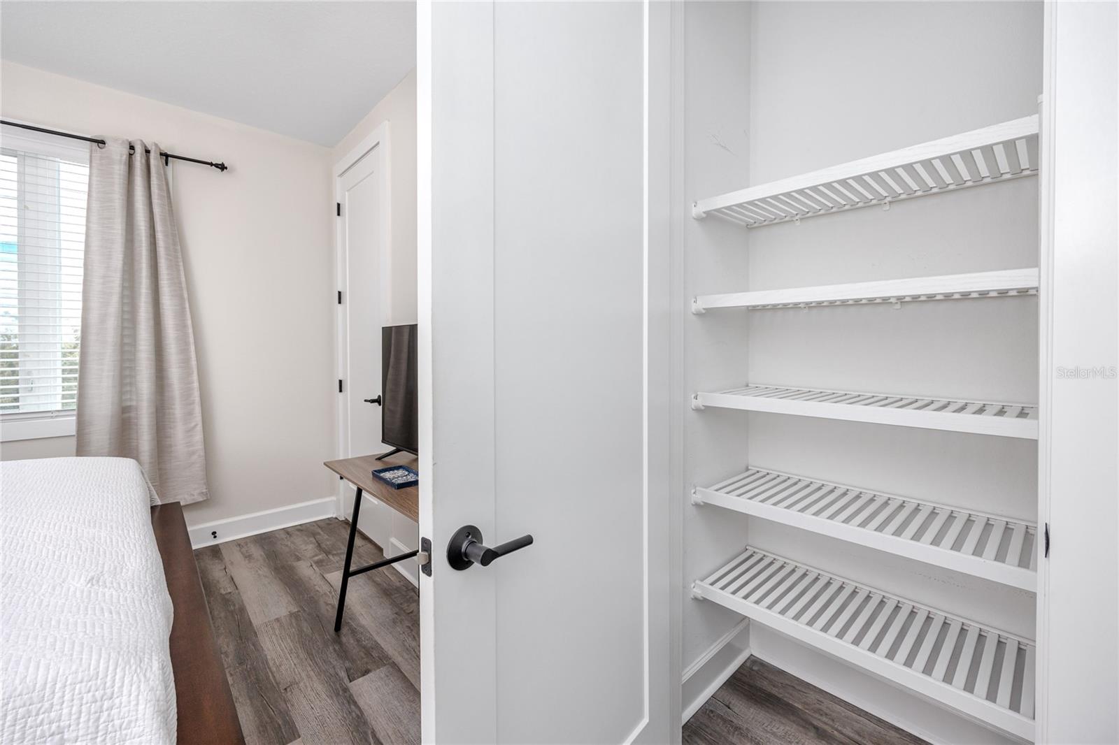 Extra closet with wood shelving