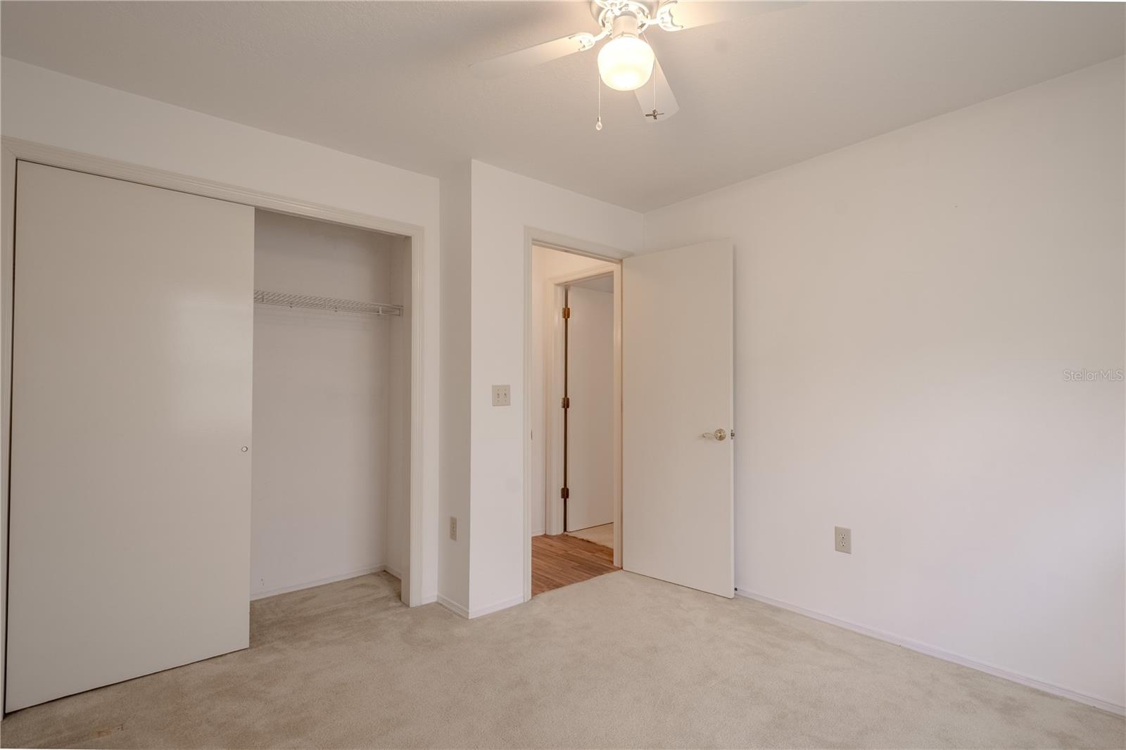 The 4h bedroom includes a ceiling fan, deep closet, and soft natural light.