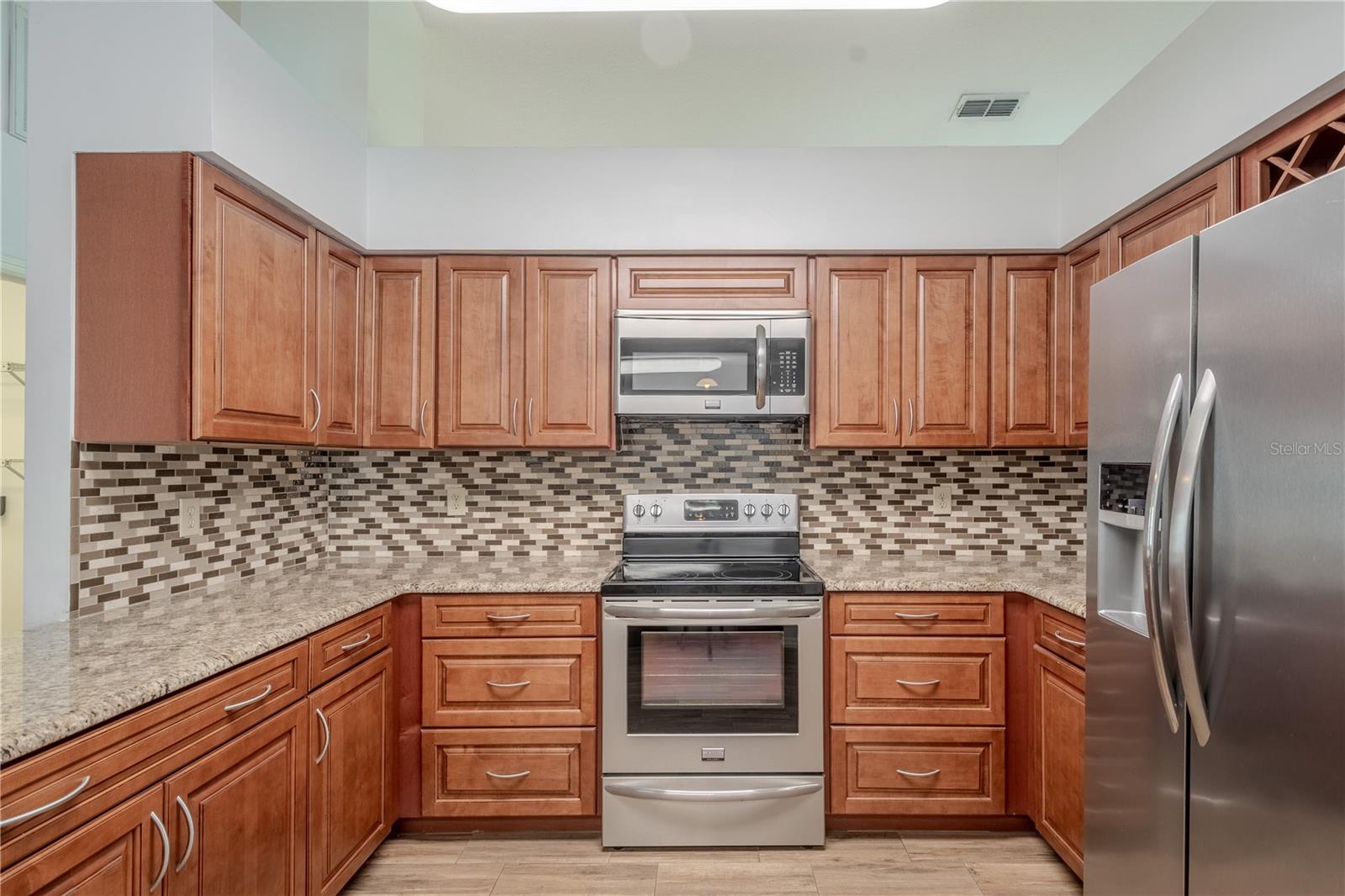 With its high ceilings, ample cabinetry, and timeless finishes, this kitchen offers the perfect balance of form and function.