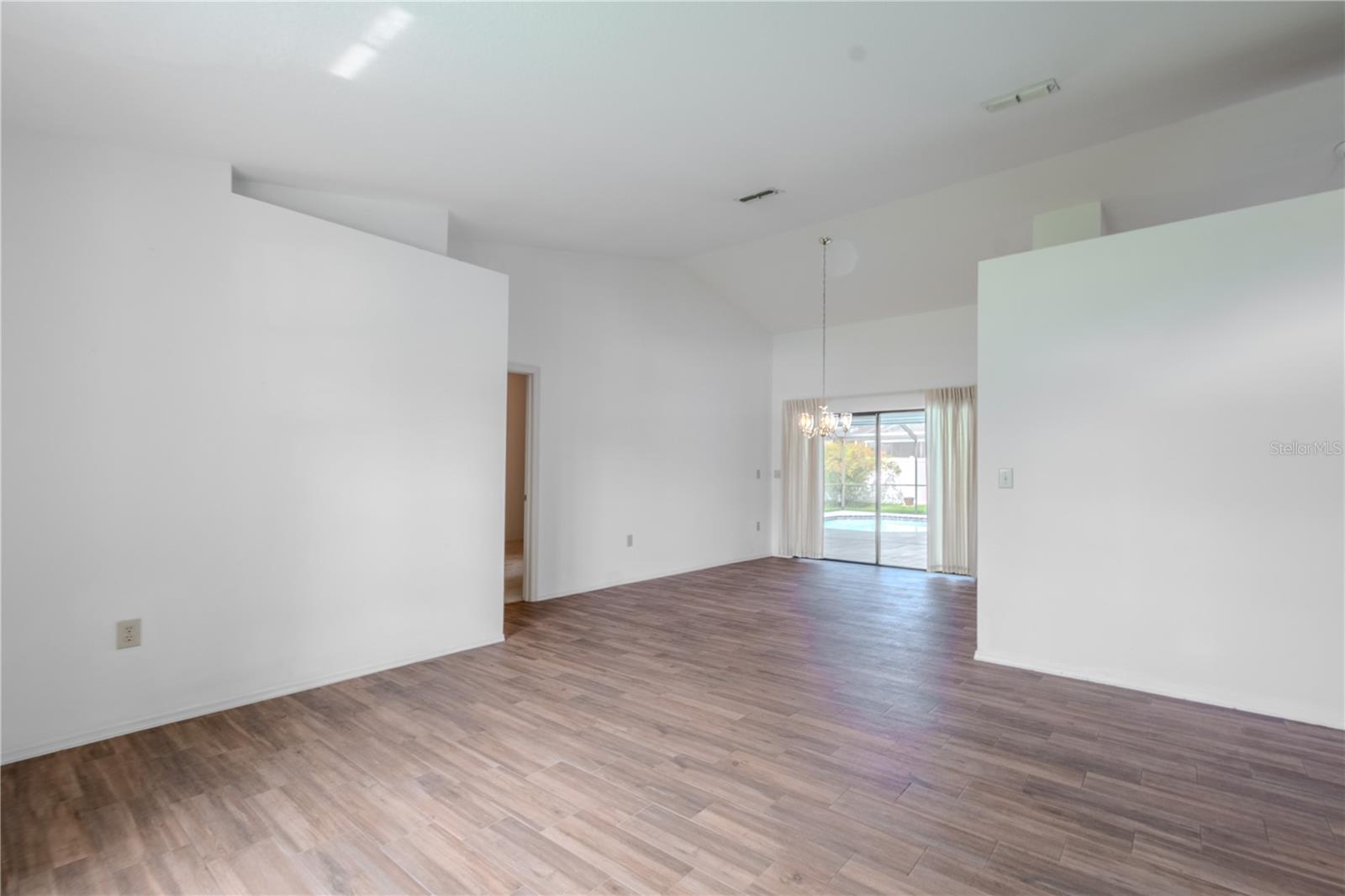 The formal dining room offers an open, airy space with soaring ceilings and a graceful flow into the rest of the home.