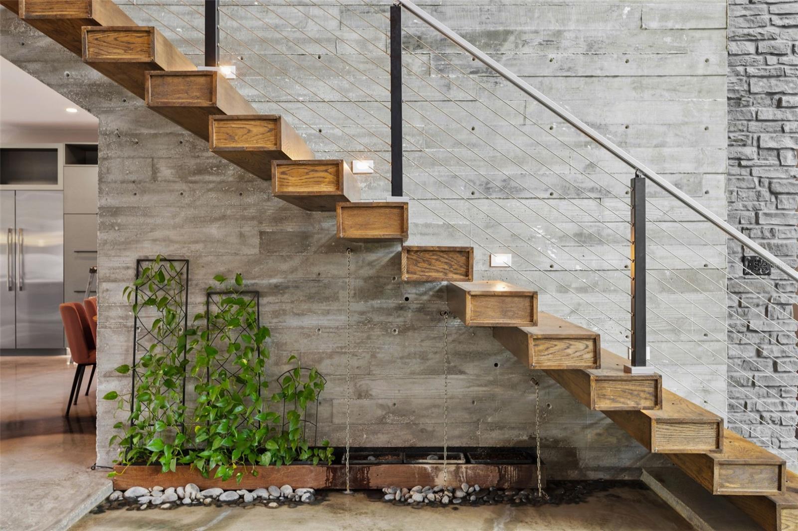 stairs to 2nd floor, fountain/hobby pond underneath