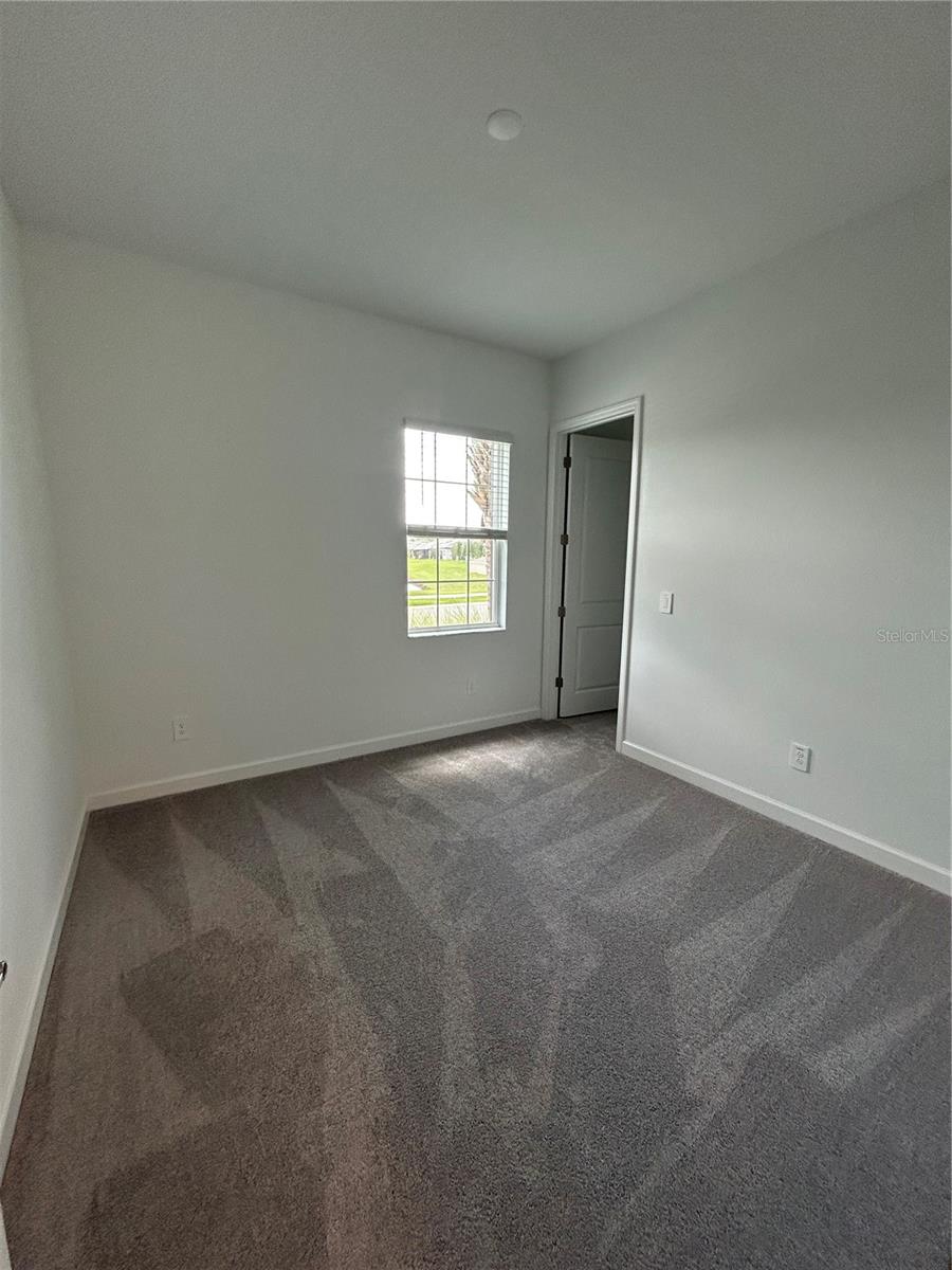 2nd Bedroom (split plan) w/Walk-in closetwith 2nd half bathroom directly across the hallway