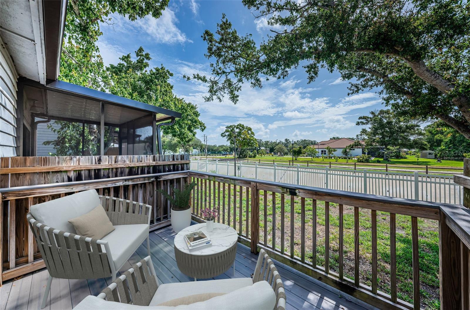 Virtually staged: Rear porch w/ a horse trail beyond the fence