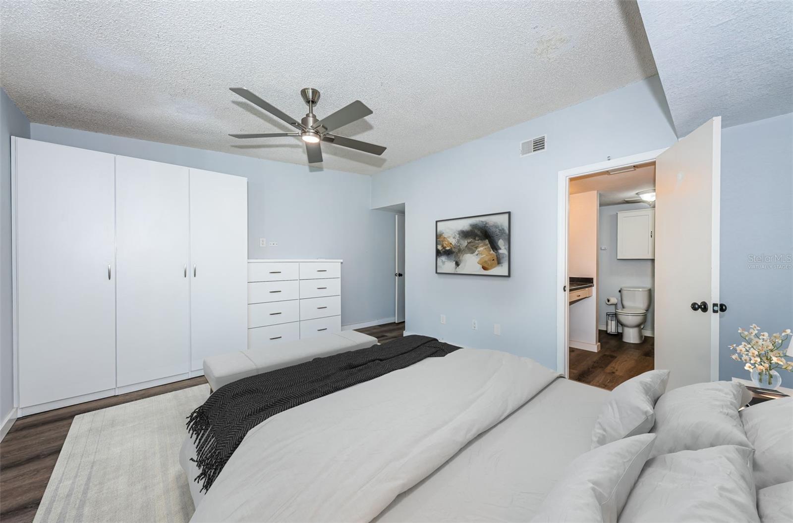 Virtually staged: Master bedroom w/ closet/drawers & ensuite bathroom