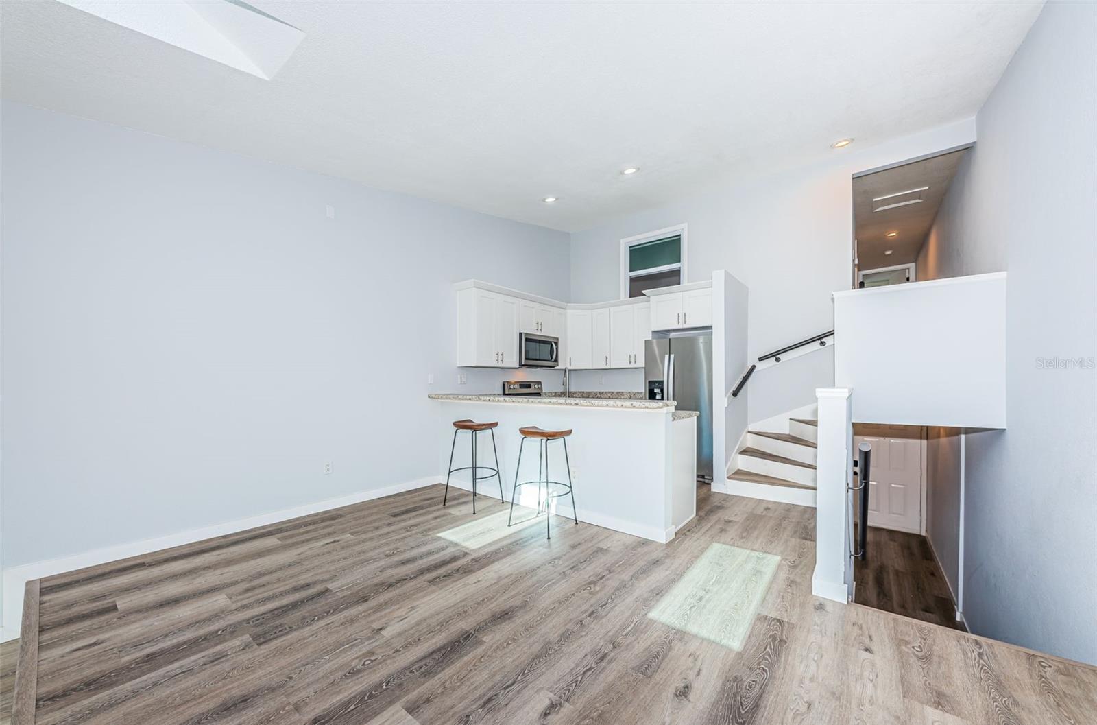 Stairs coming up from foyer to the 2nd level, newer luxury vinyl flooring/paint/base boards throughout