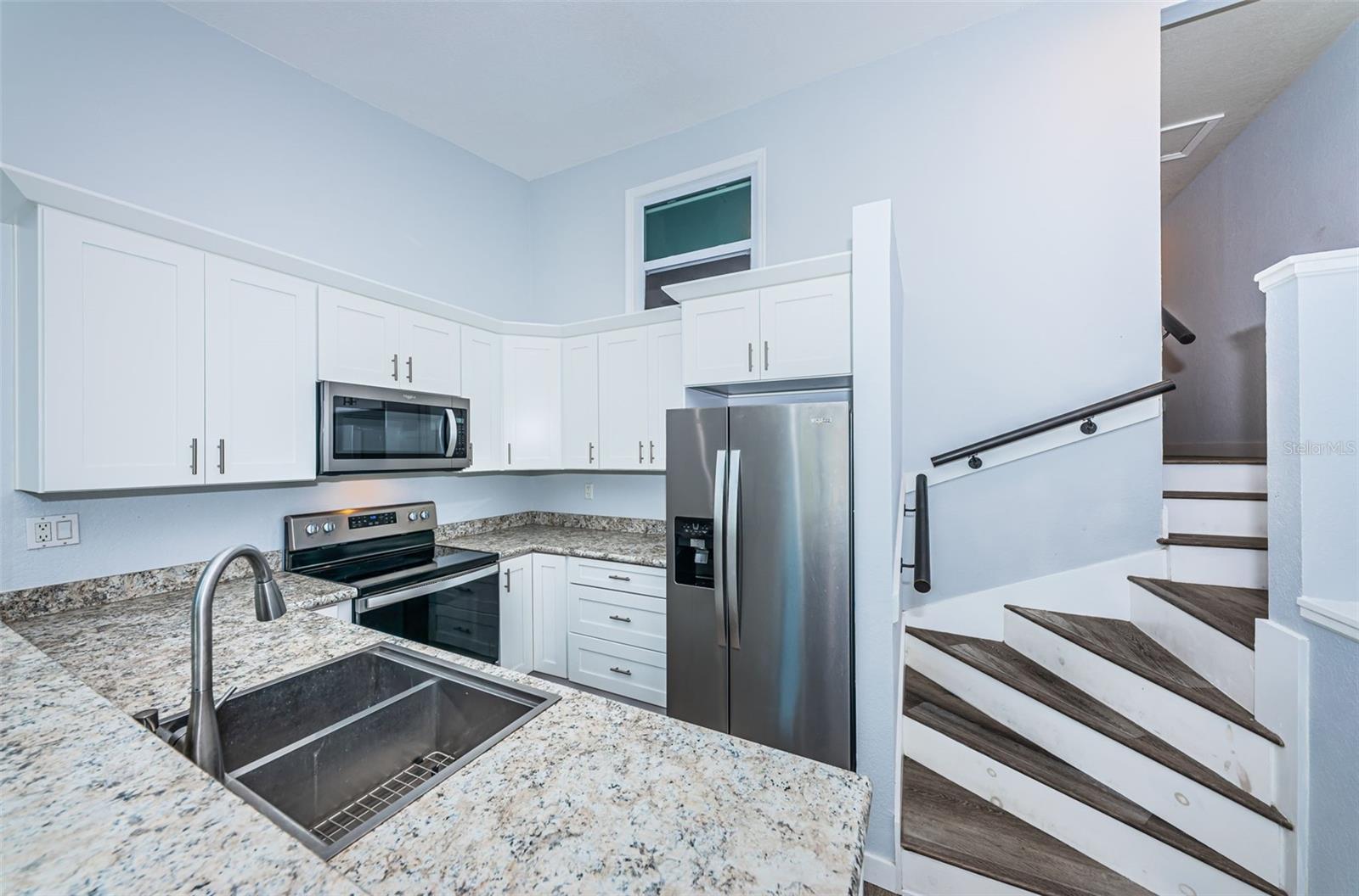 Kitchen, w/ shaker cabinets, soft close drawers, stainless steel appliances, double sink, sensor faucet, & GFCIs.