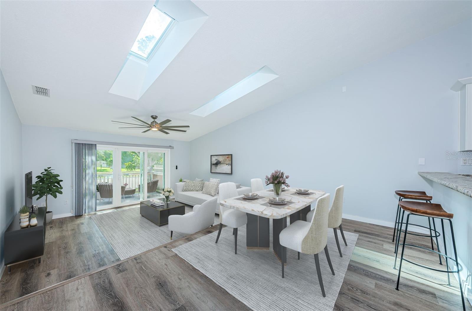 Virtually staged: Dining area, great room, high ceiling & impact slider to the rear porch