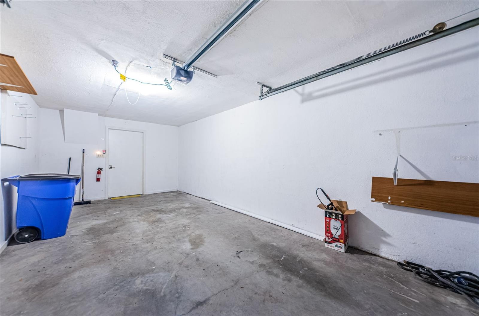 Garage looking toward entry way going into the utility room (floor is now cleaned)