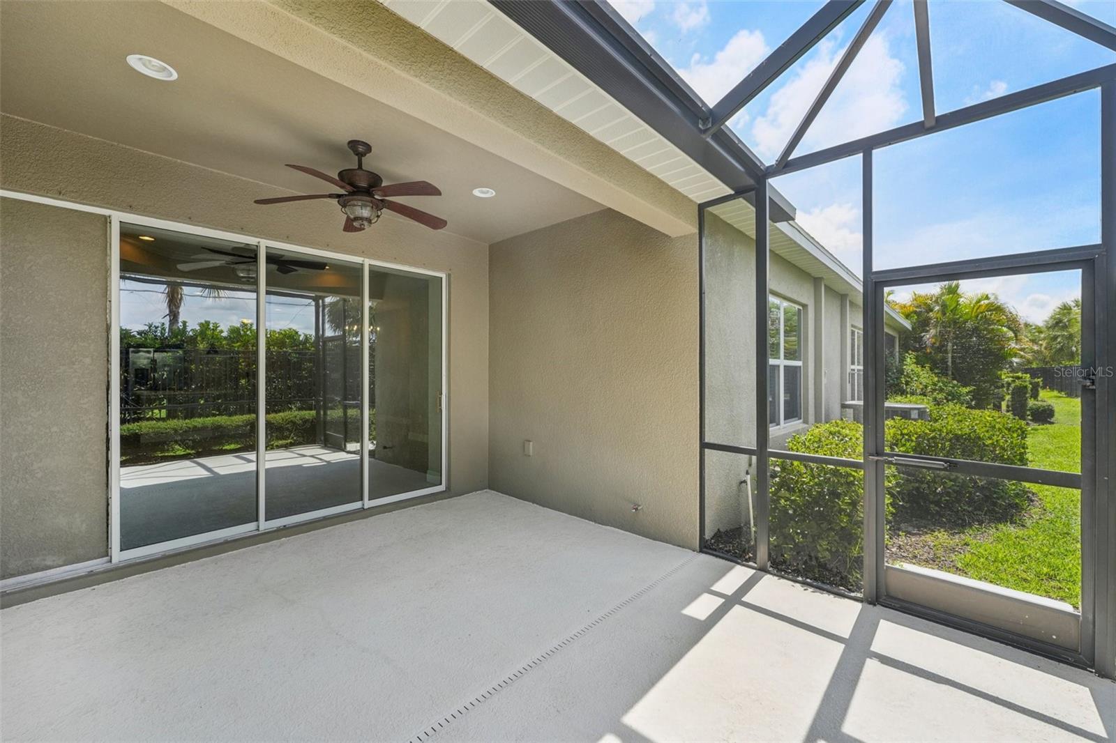 POCKET SLIDING DOORS LEAD TO A SCREENED LANAI FOR EARLY MORNING COFFEE
