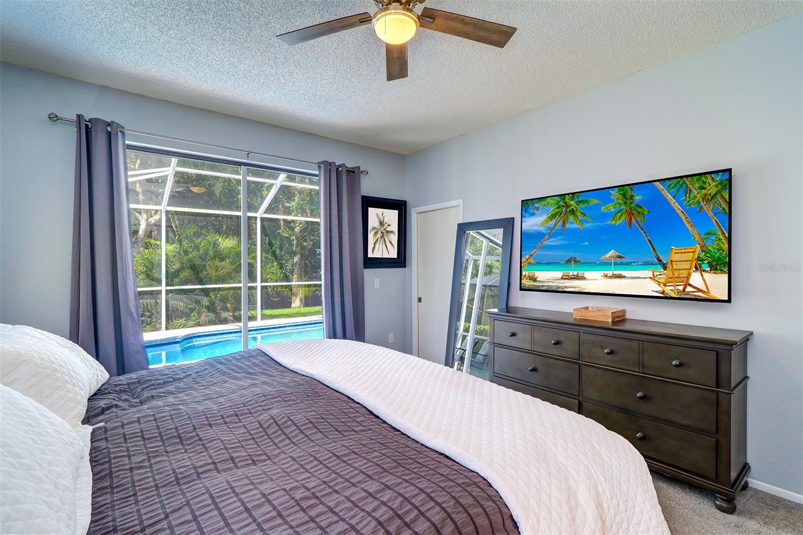 View of primary bedroom overlooking pool