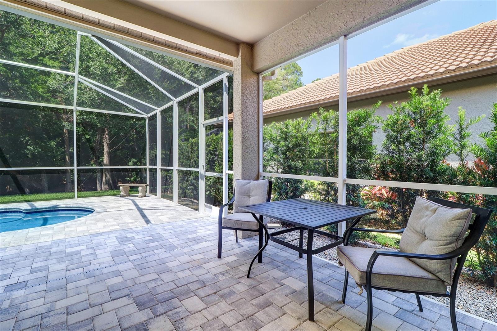 Covered lanai overlooking pool andconservation area