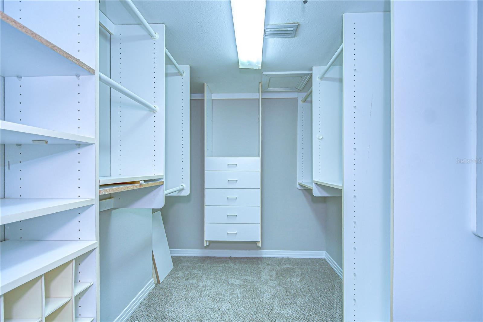 This walk-in closet has tons of space and built ins to help with organization!