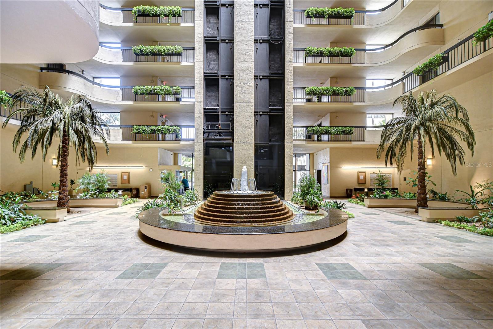 Lush tropical landscaping and a welcoming, fountain-adorned lobby!