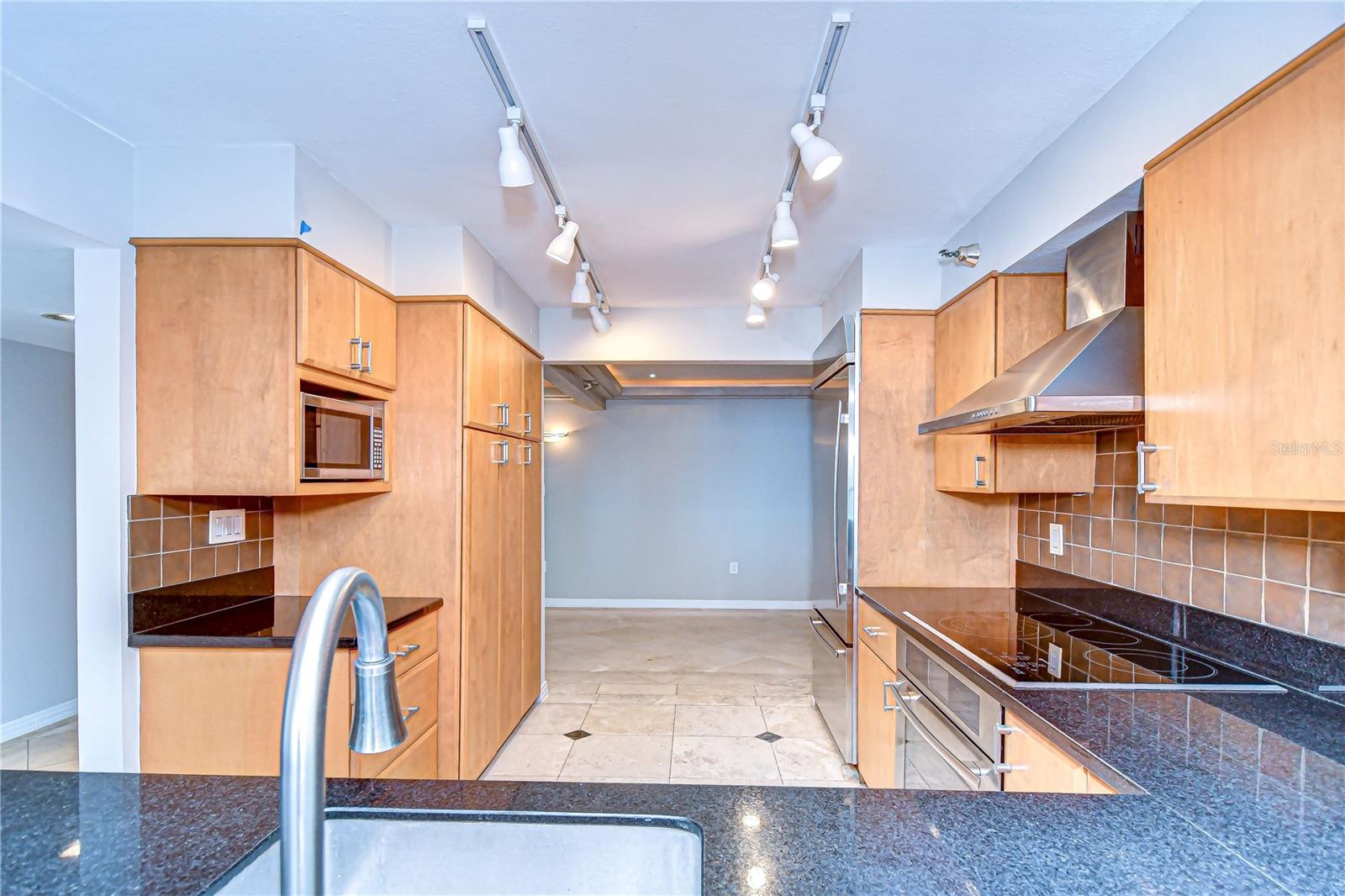 Stylish black granite and tile backsplash elevate the space!