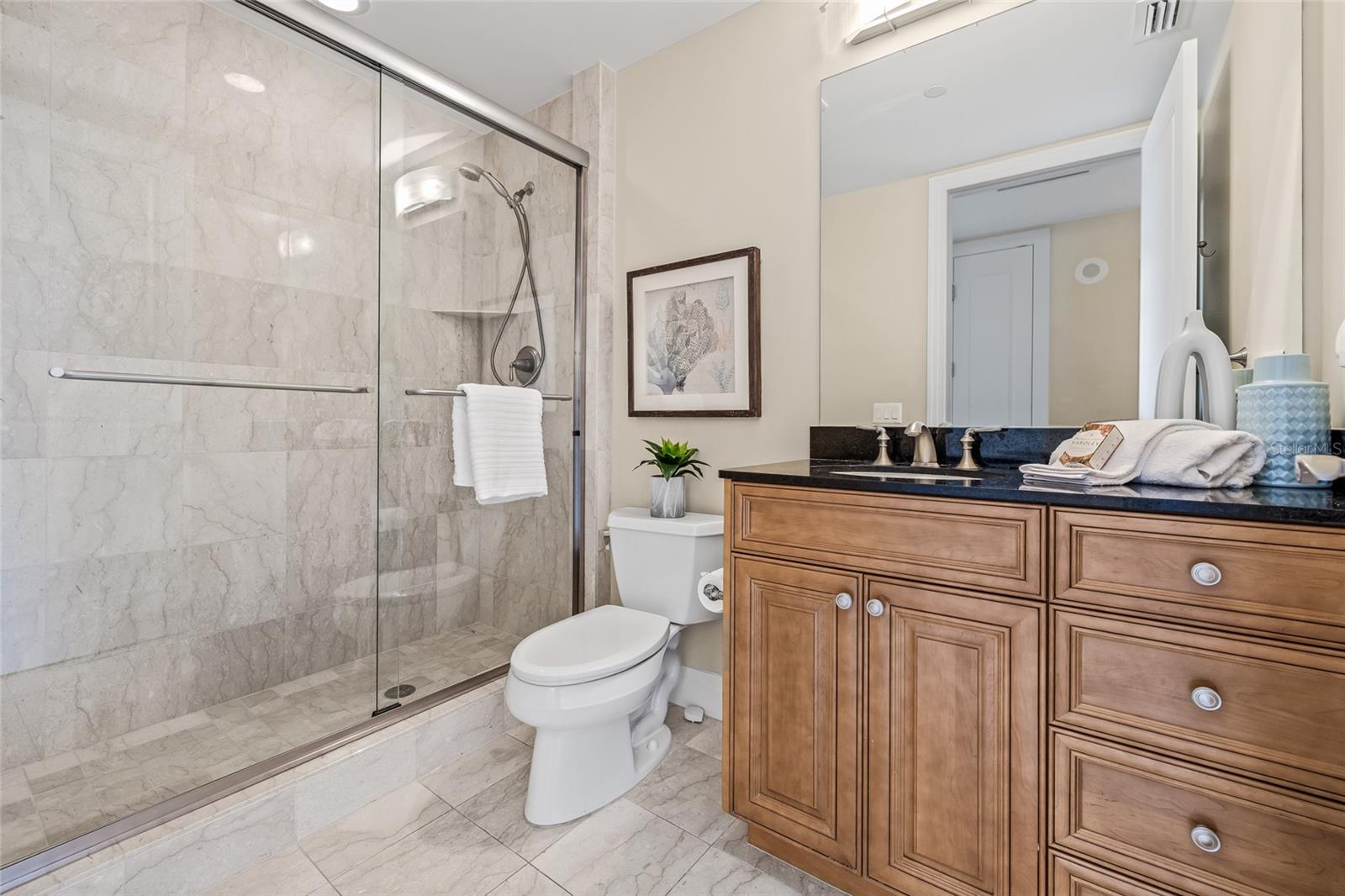 The guest bathroom with a glass-enclosed shower.