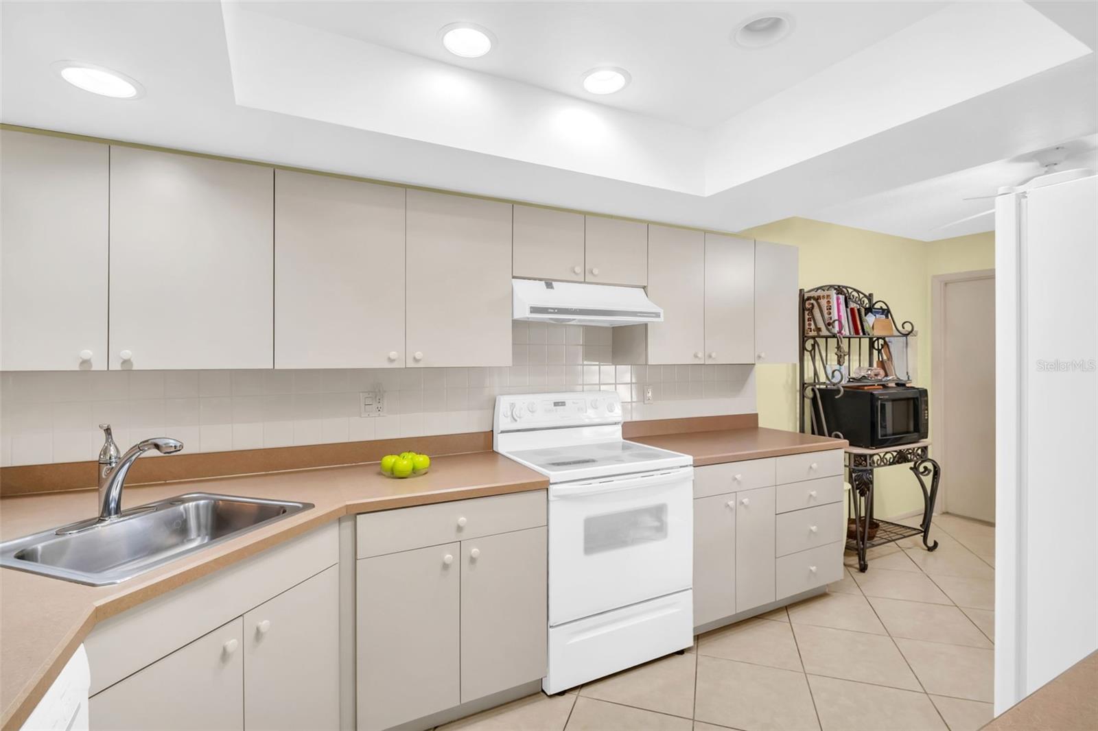 Loads of cabinet space with updated appliances & recessed lighting~