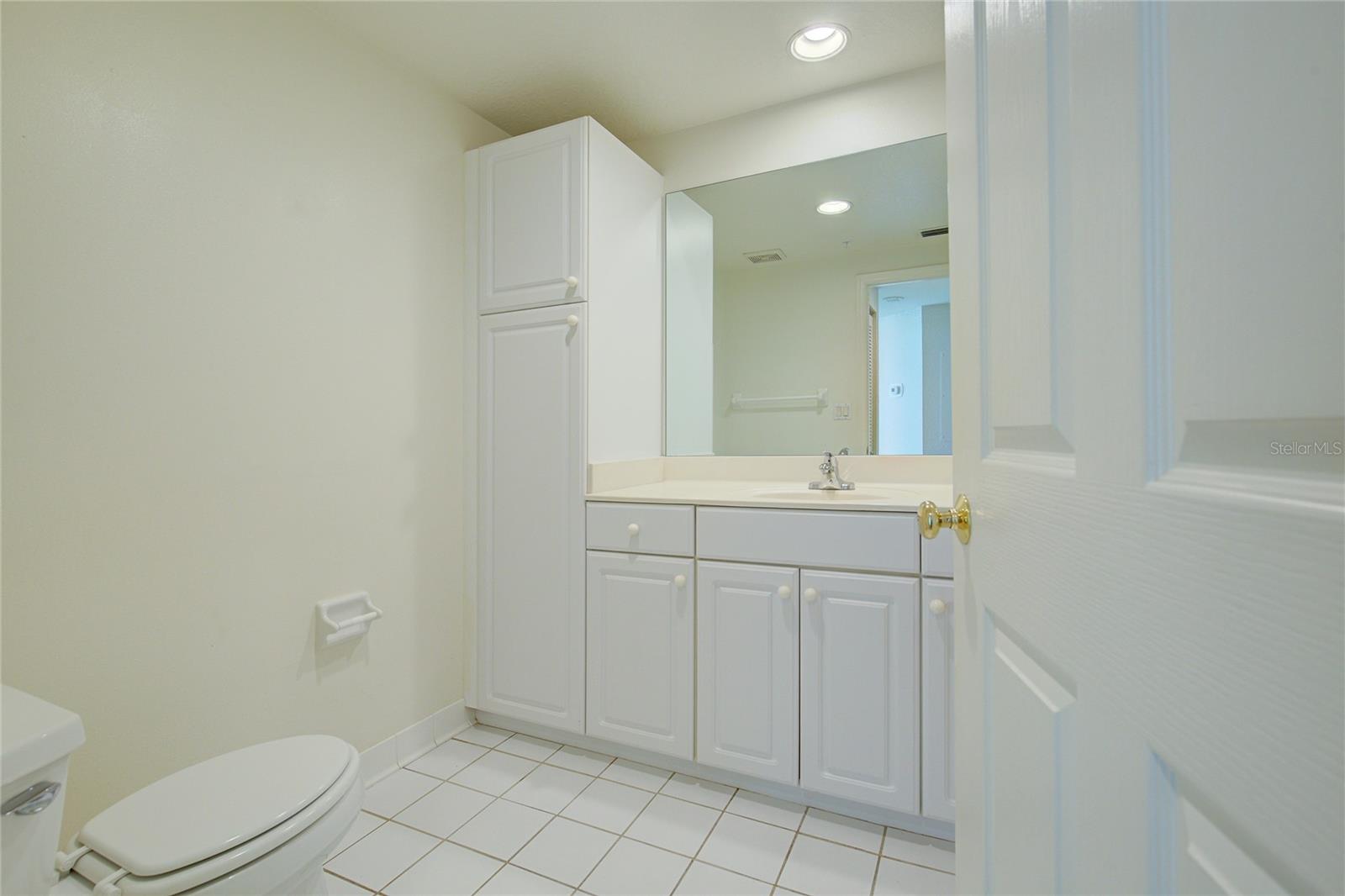 The guest bath, steps from the guest bedroom is open, light and bright with plenty of storage!