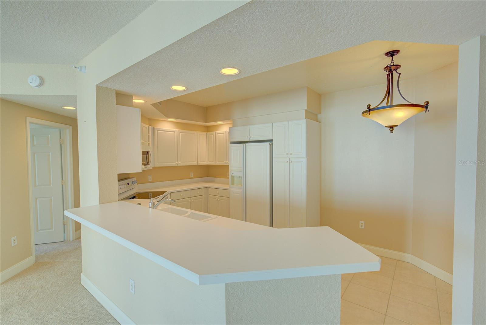 Clean white cabinetry, bosch dishwasher and plenty of room for a dining table for an eat-in experience.