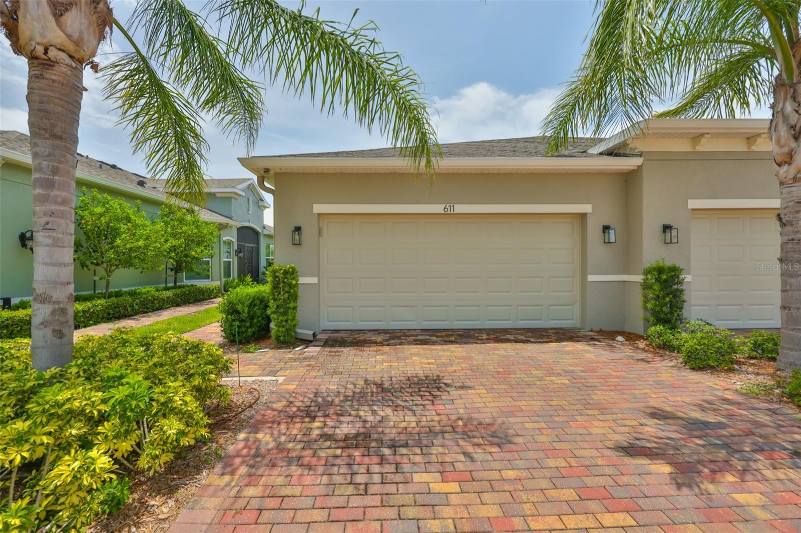 Beautifully landscaped with brick pavers accenting the driveway and walkway to the front door.