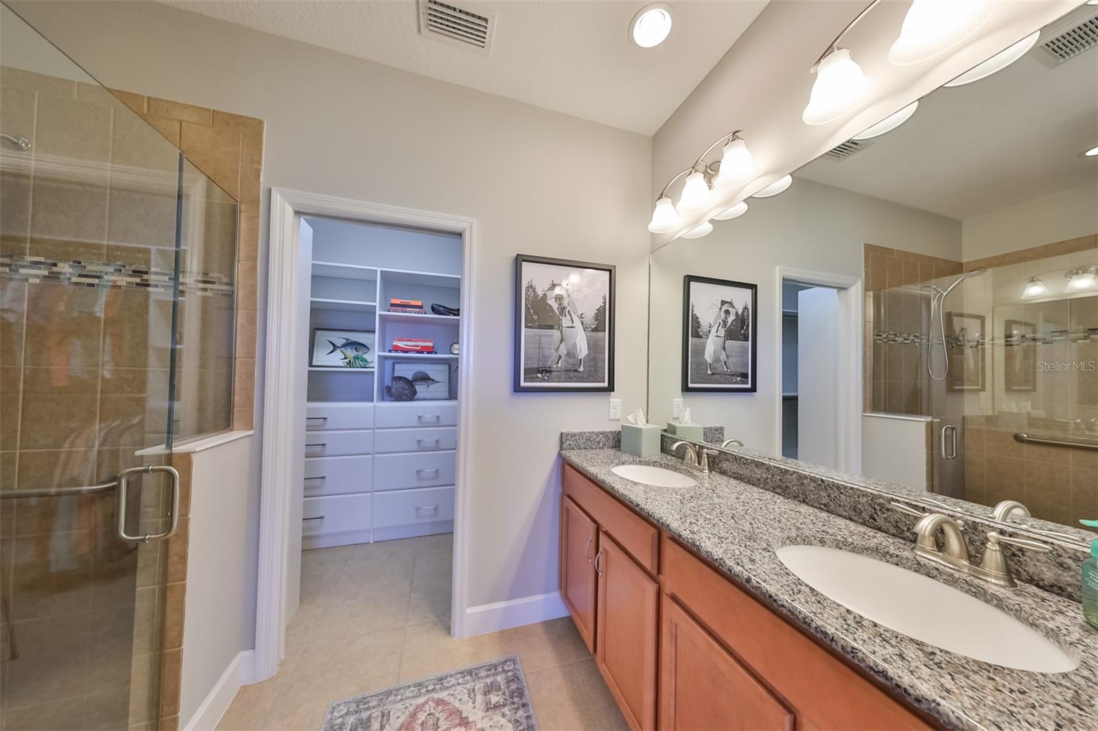 Master bathroom is updated with walk in shower, high counters and dual granite sinks.