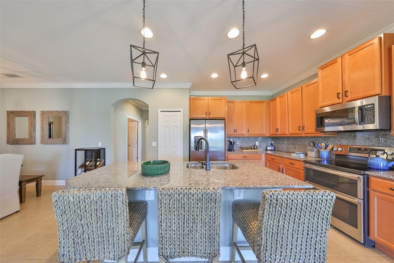 The kitchen has lots of storage space, a good size pantry and matching stainless-steel appliances (including a double oven).