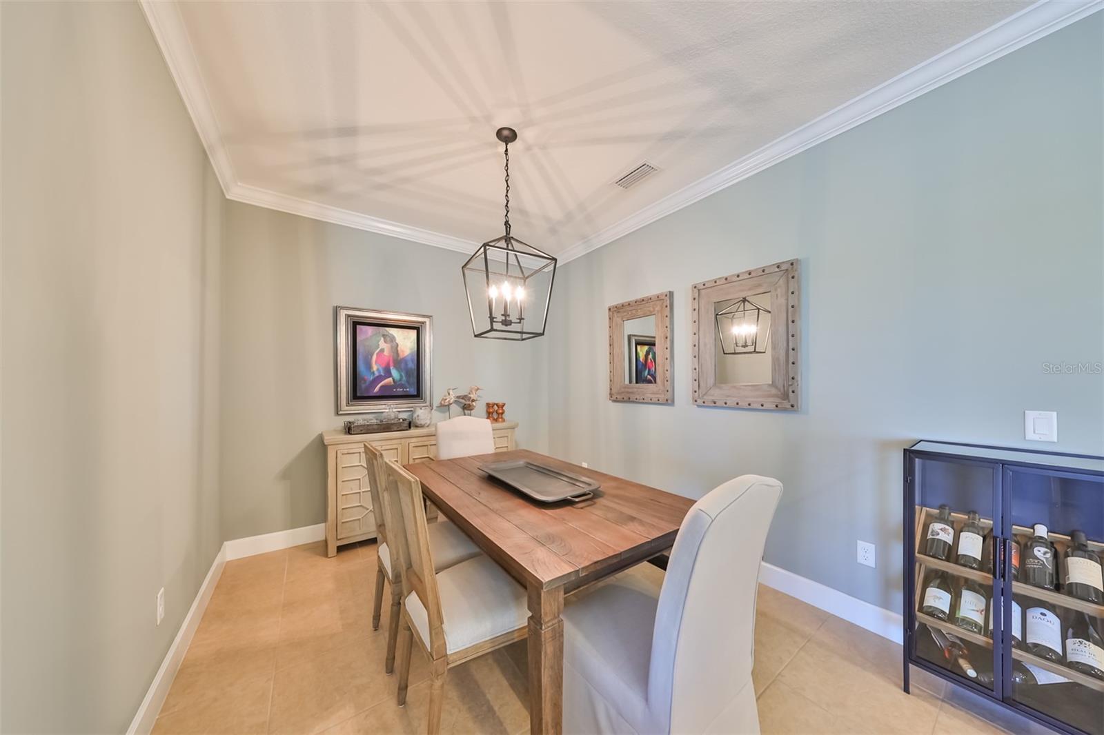 The dining room is a cozy, but open space for those intimate dinners, or playing cards with the neighbors. With the crown molding and soft hues, it is comfortable and elegant.