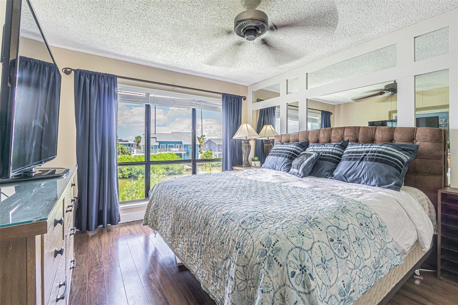 Owners suite with King bed and mirrored accents to reflect water