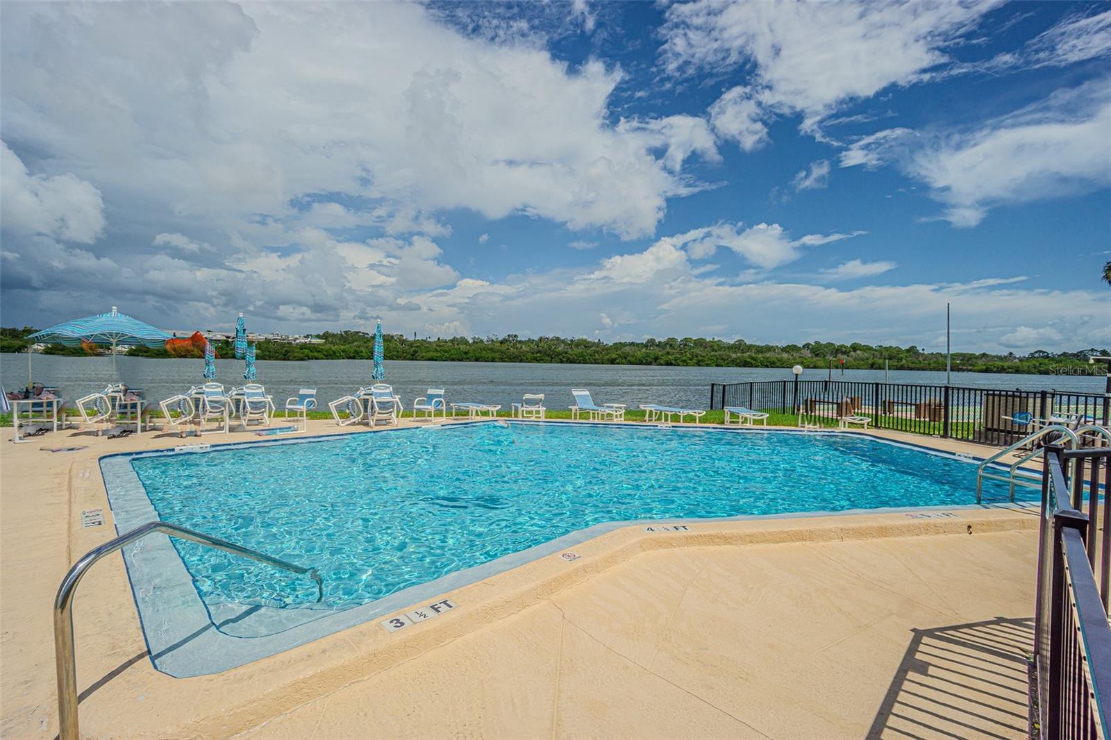 Community pool overlooks water for a relaxing afternoon!