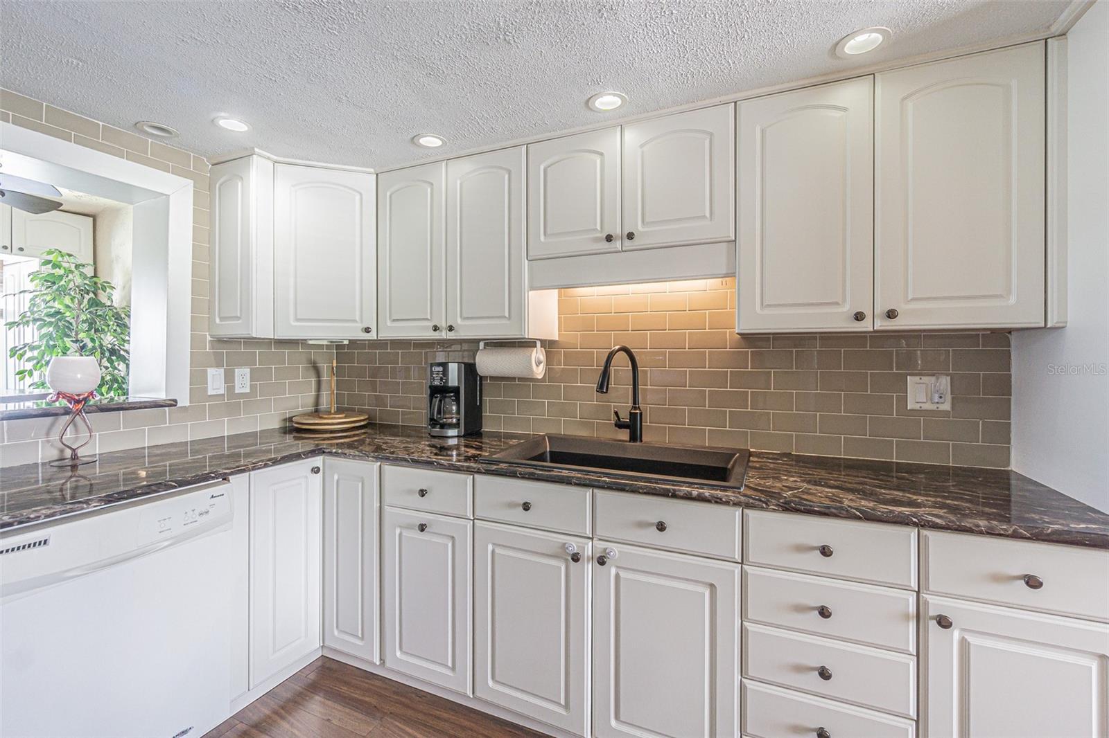 Light, bright white kitchen with pass thru to bonus room