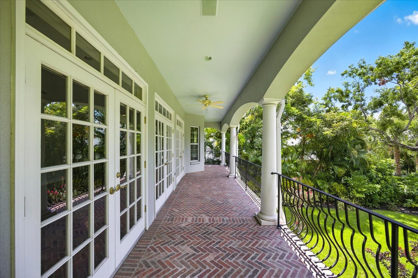 covered balcony with 3 sets of French doors
