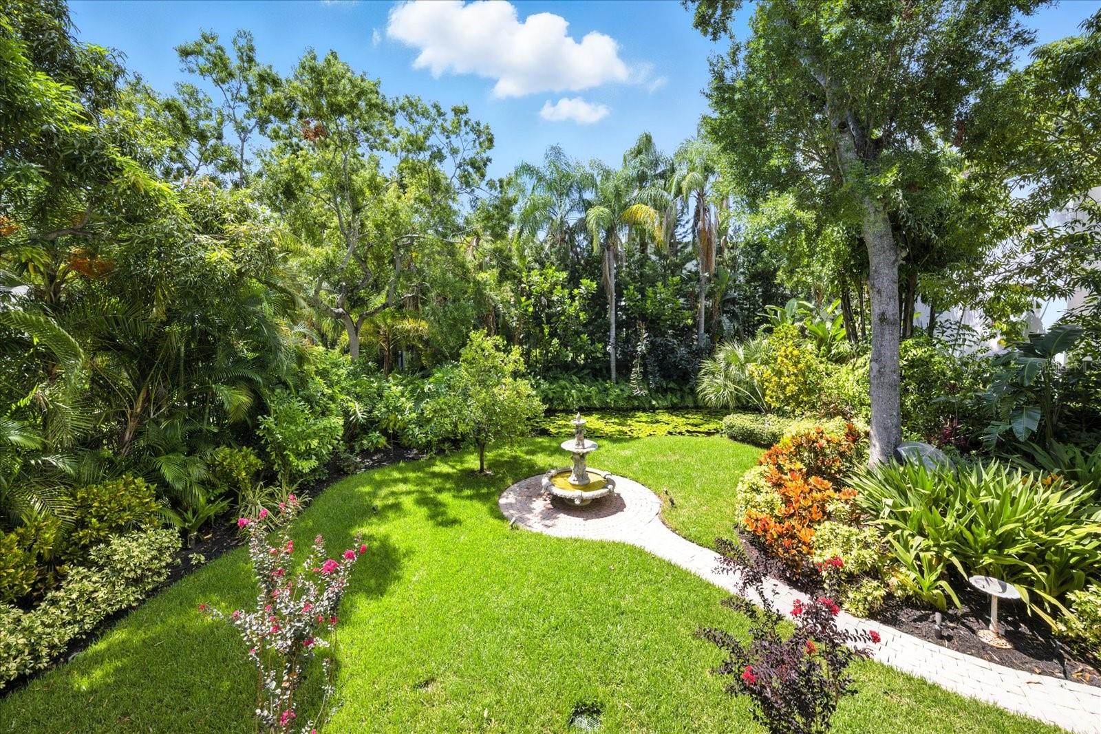 Private tropical oasis with man-made pond and fountain