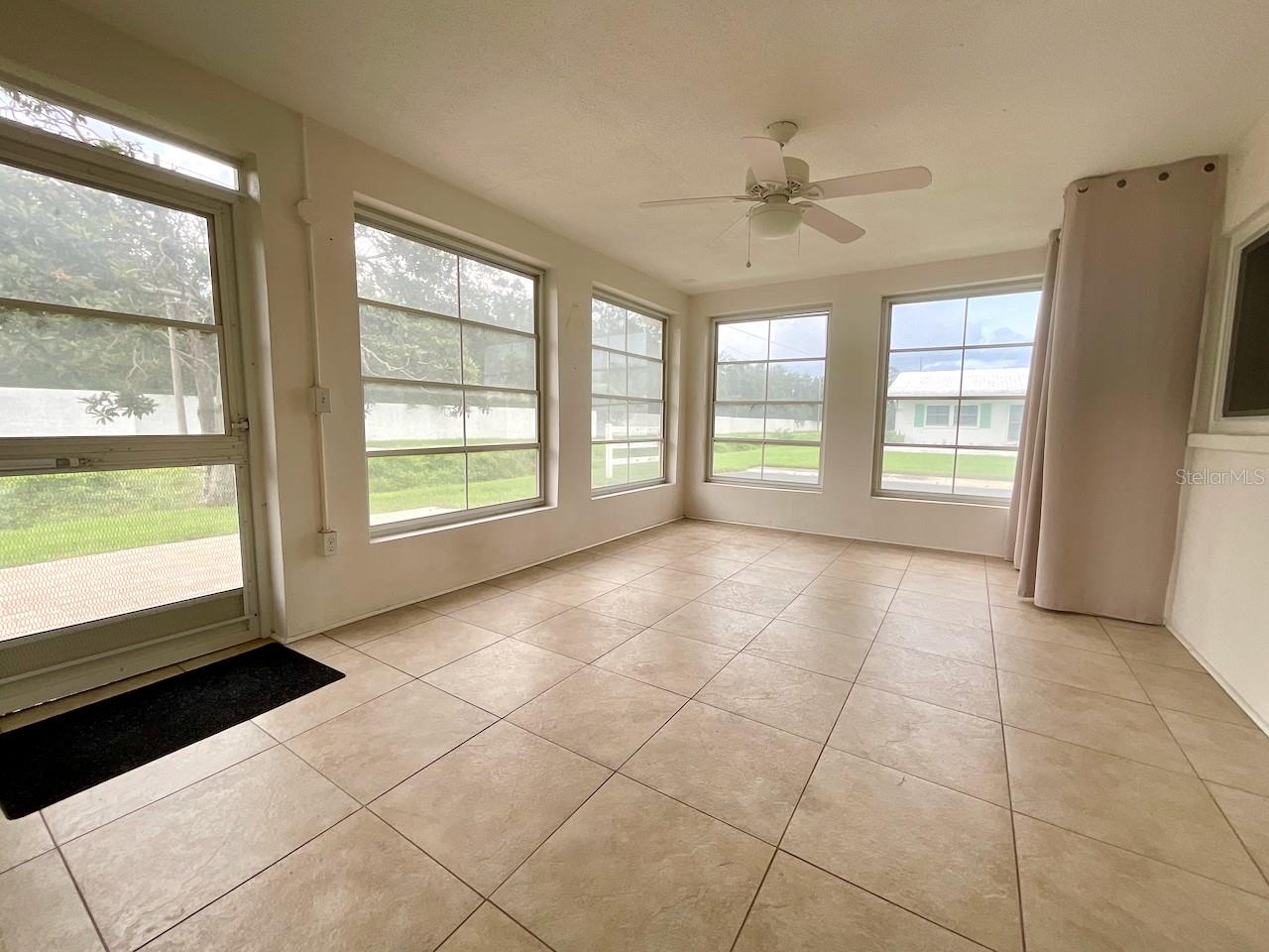 Covered Lanai with screen, plastic windows and tile floor
