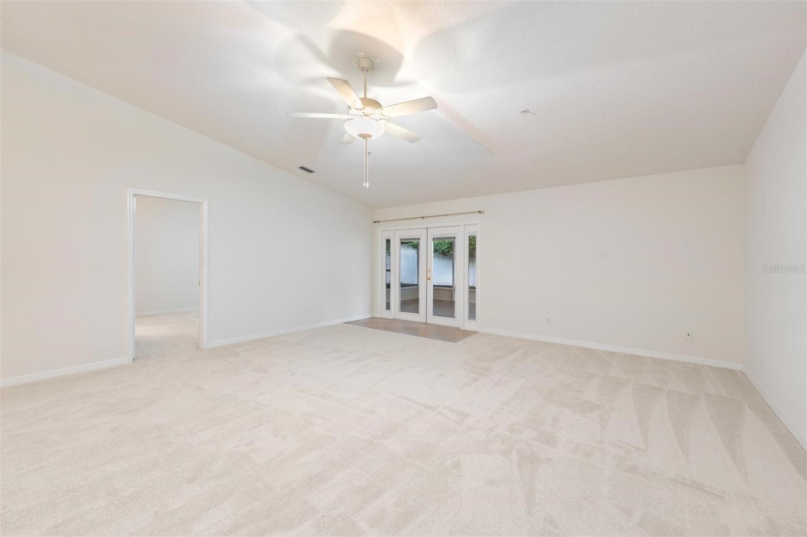 French Doors to the lanai, All New Carpet, Vaulted Ceilings, Ceiling Fan with light fixture.