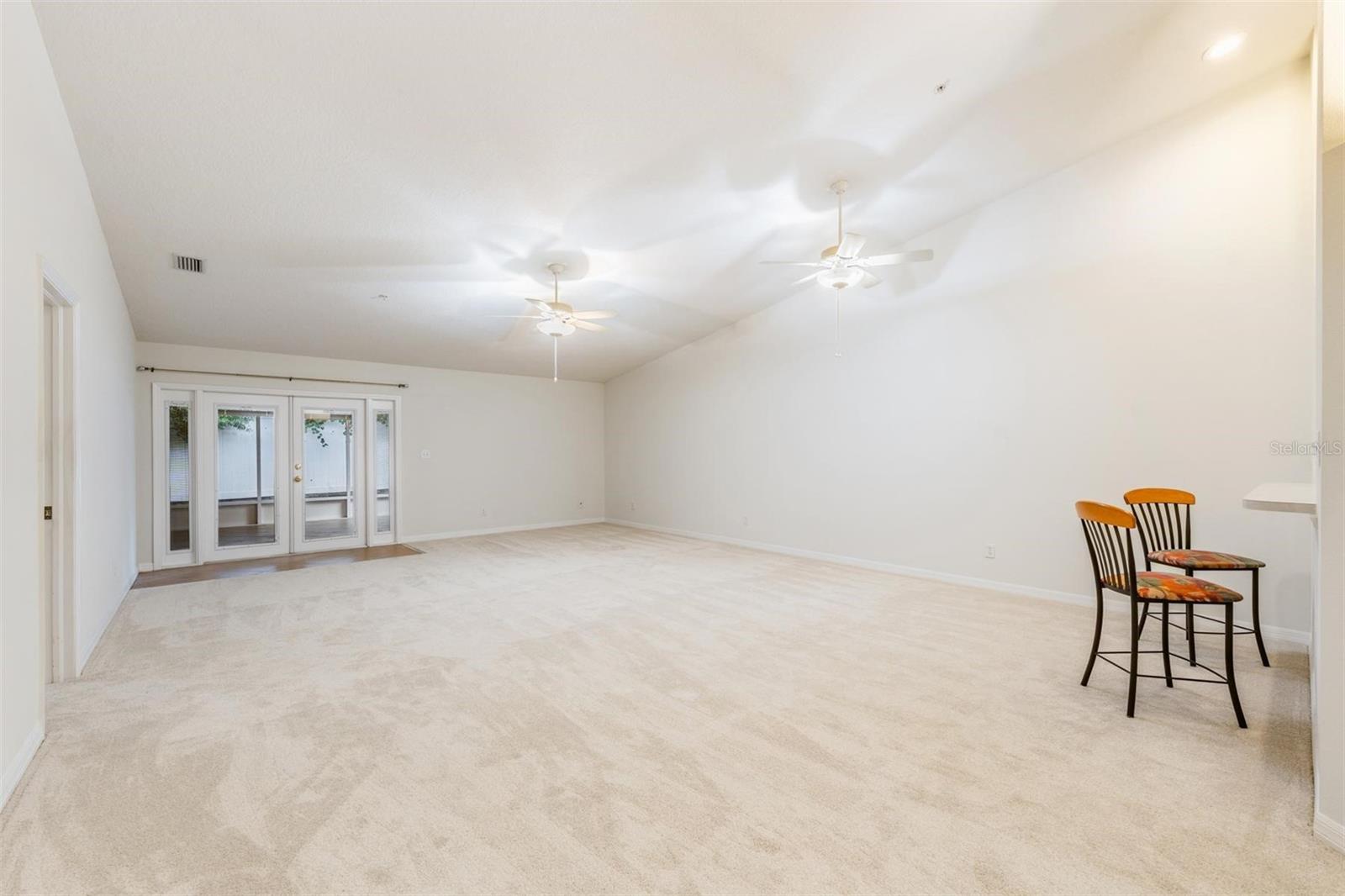 Huge Great Room, Vaulted Ceilings, French Doors to the Lanai, All New Carpet, Ceiling Fans with Light Fixture.