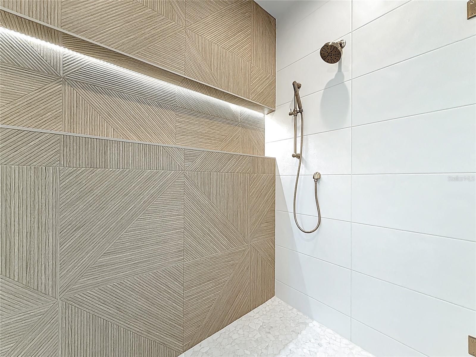 Spa-like en-suite bath featuring dual sinks, an oversized walk-in shower, and a private water closet.