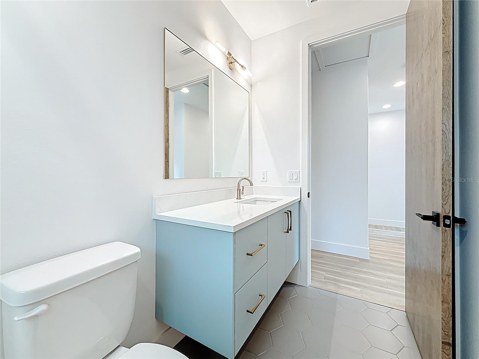 Stylish guest bath with tub/shower combo and sleek modern finishes.