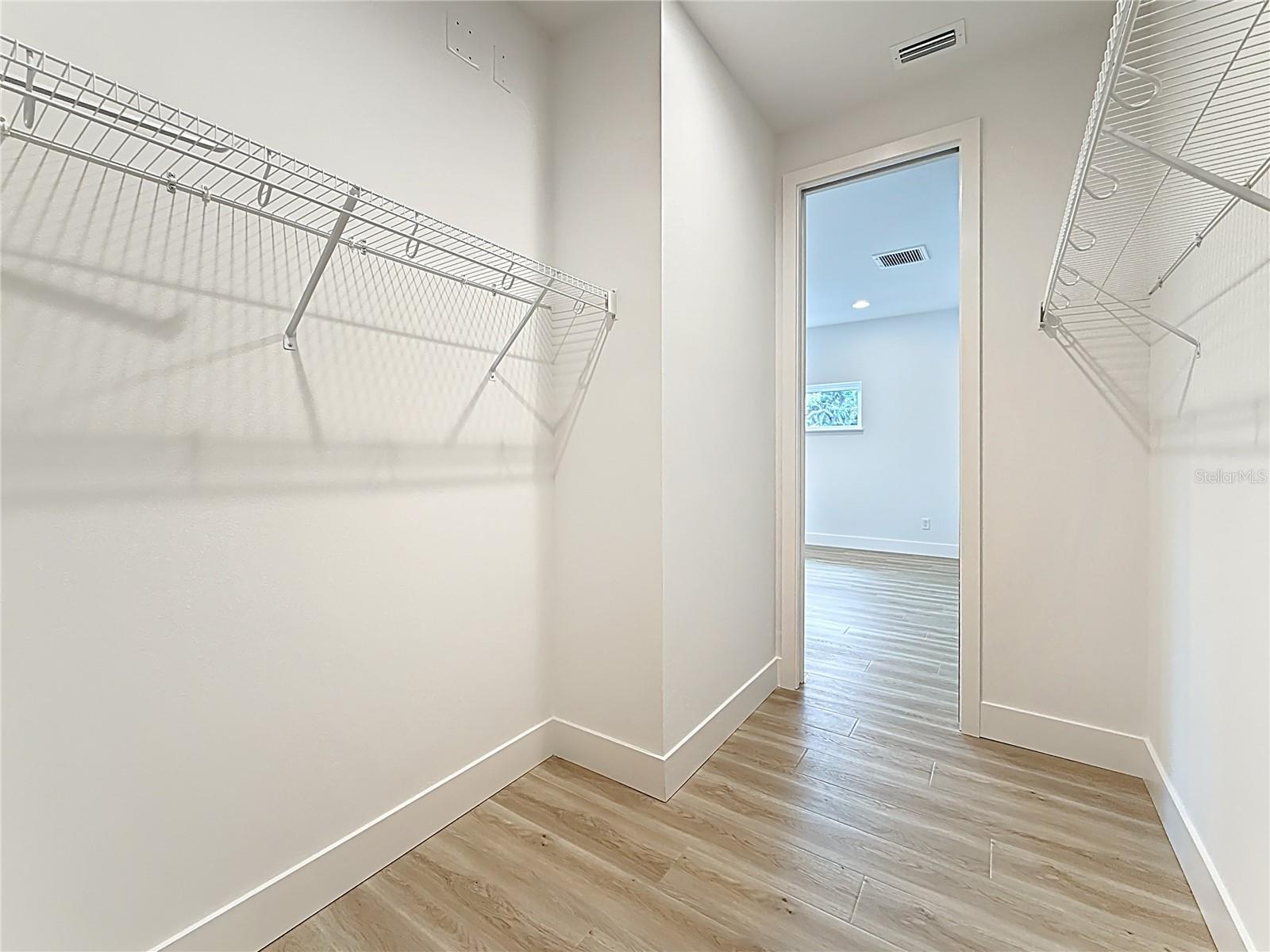 Primary suite walk-in closet.