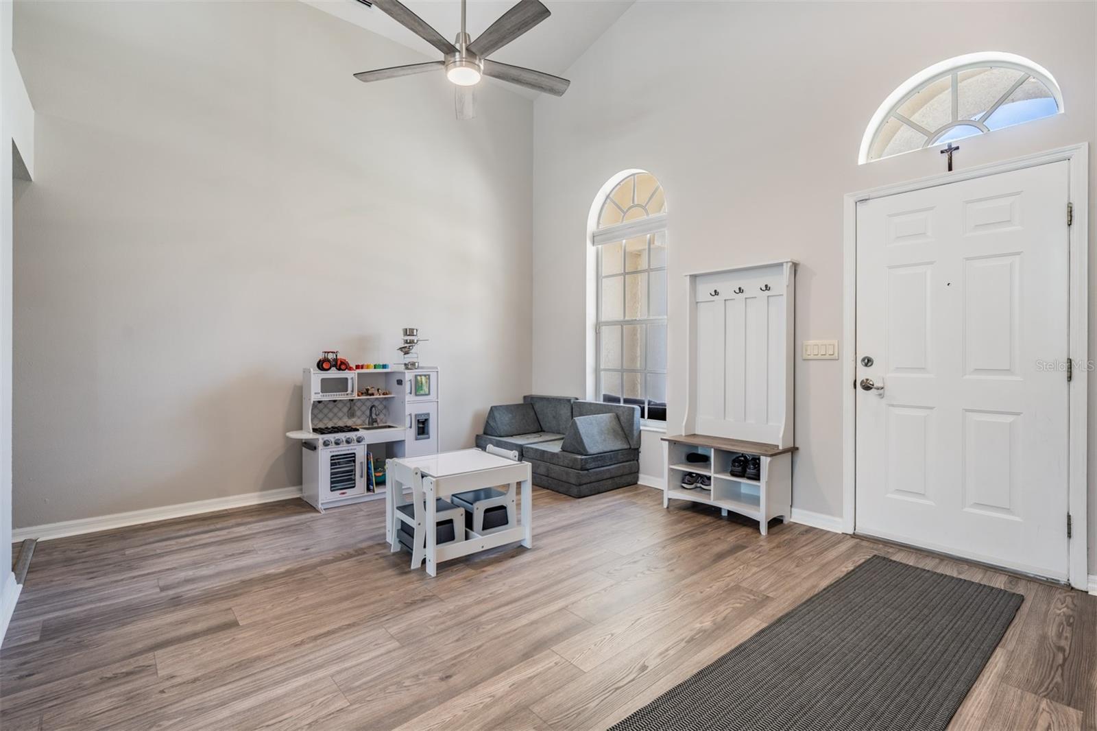 Formal Dining Room area ( this family uses this space as an office and a play area for the children). New LVP Flooring, Vaulted Ceilings, Inset Lighting, Ceiling fan with light fixture.