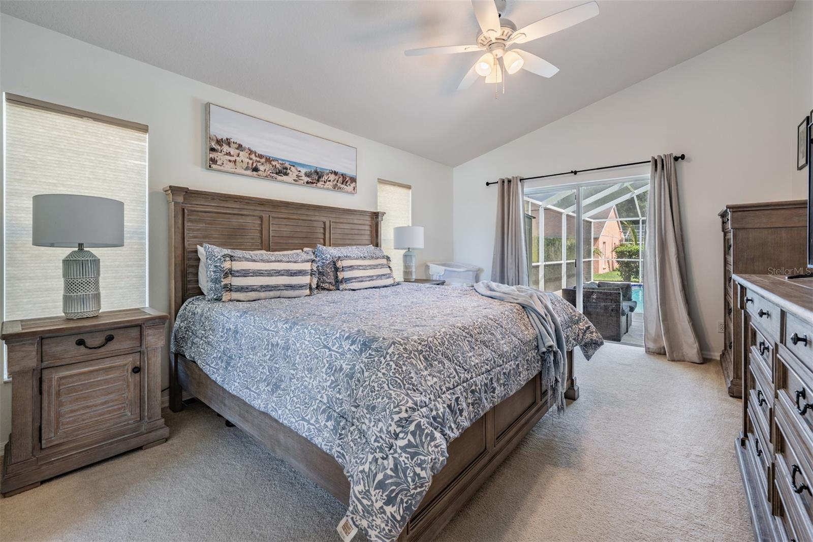 Master Bedroom, ceiling light and fan and view of the pool/lanai.