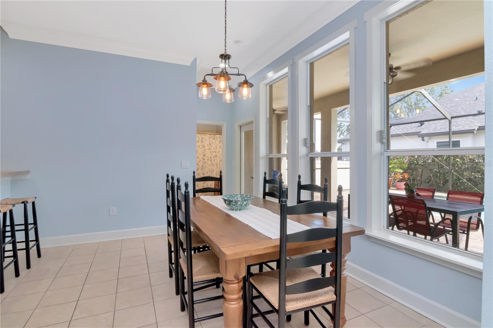 Eat-In Kitchen Area and Backdrop of Windows & View of Pool