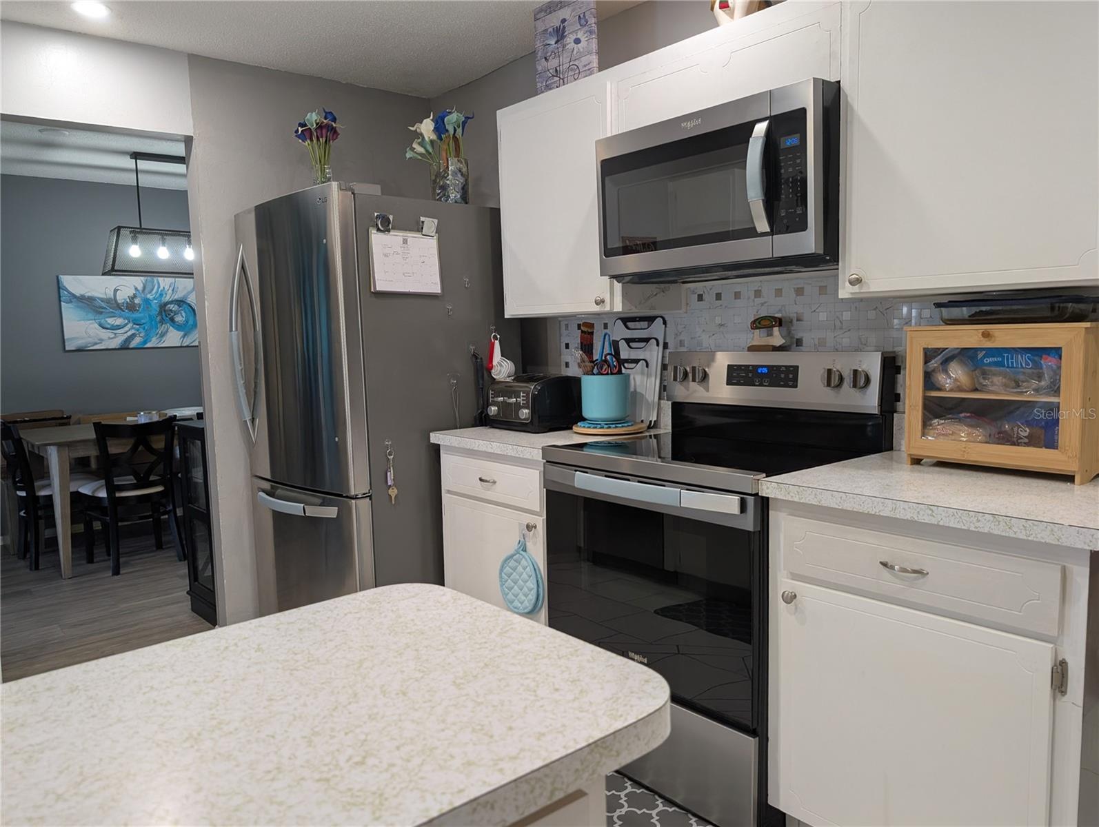 Galley kitchen features newer stainless steel appliances including LG Refrigerator w/bottom freezer (2022), WP Range and Microwave (2025).