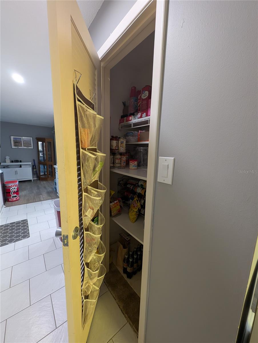 Closet pantry in hallway.