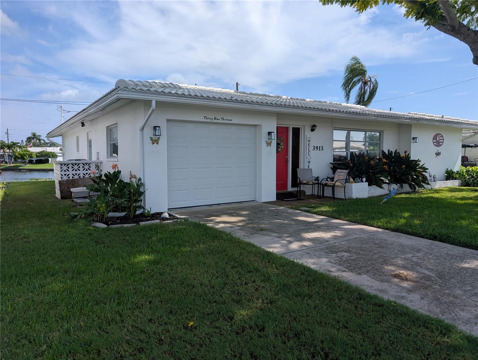 Exterior features tile roof (2021) and gutters/down spouting.  Garage door is an impact rated Amarr reinforced door with a Linear door opener. Exterior maintenance including roof repair/replacement, painting and lawn care is included in maintenance fees.