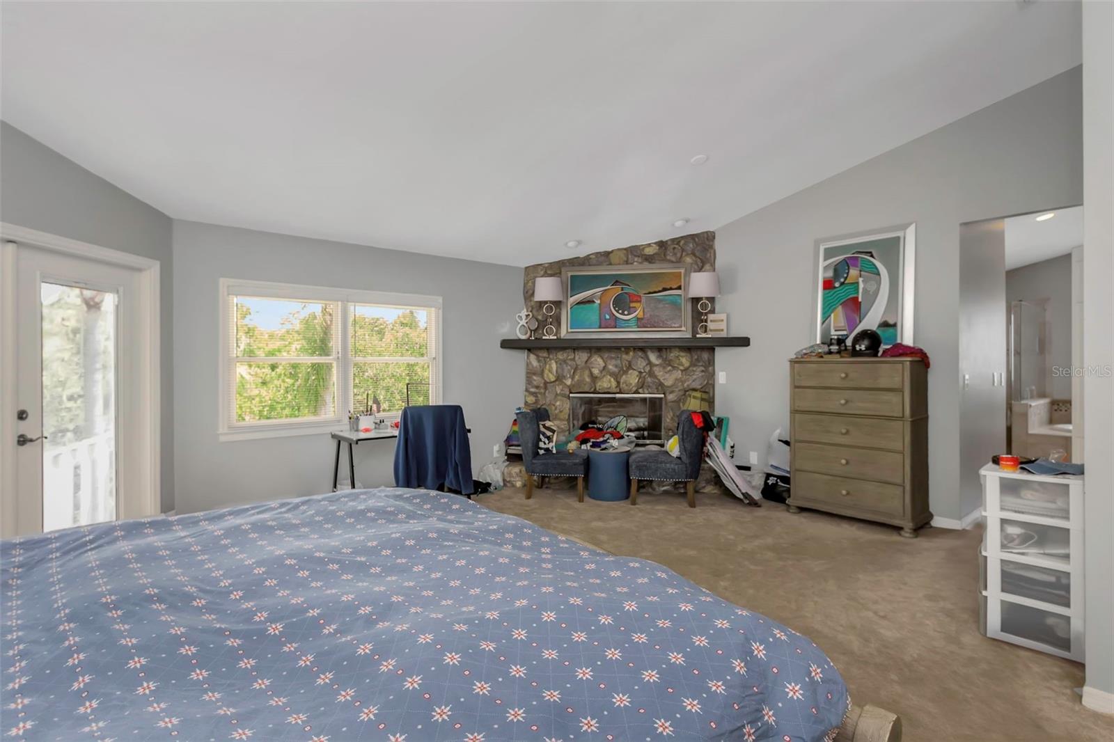 Primary Bedroom with french doors out to the patio with a view.