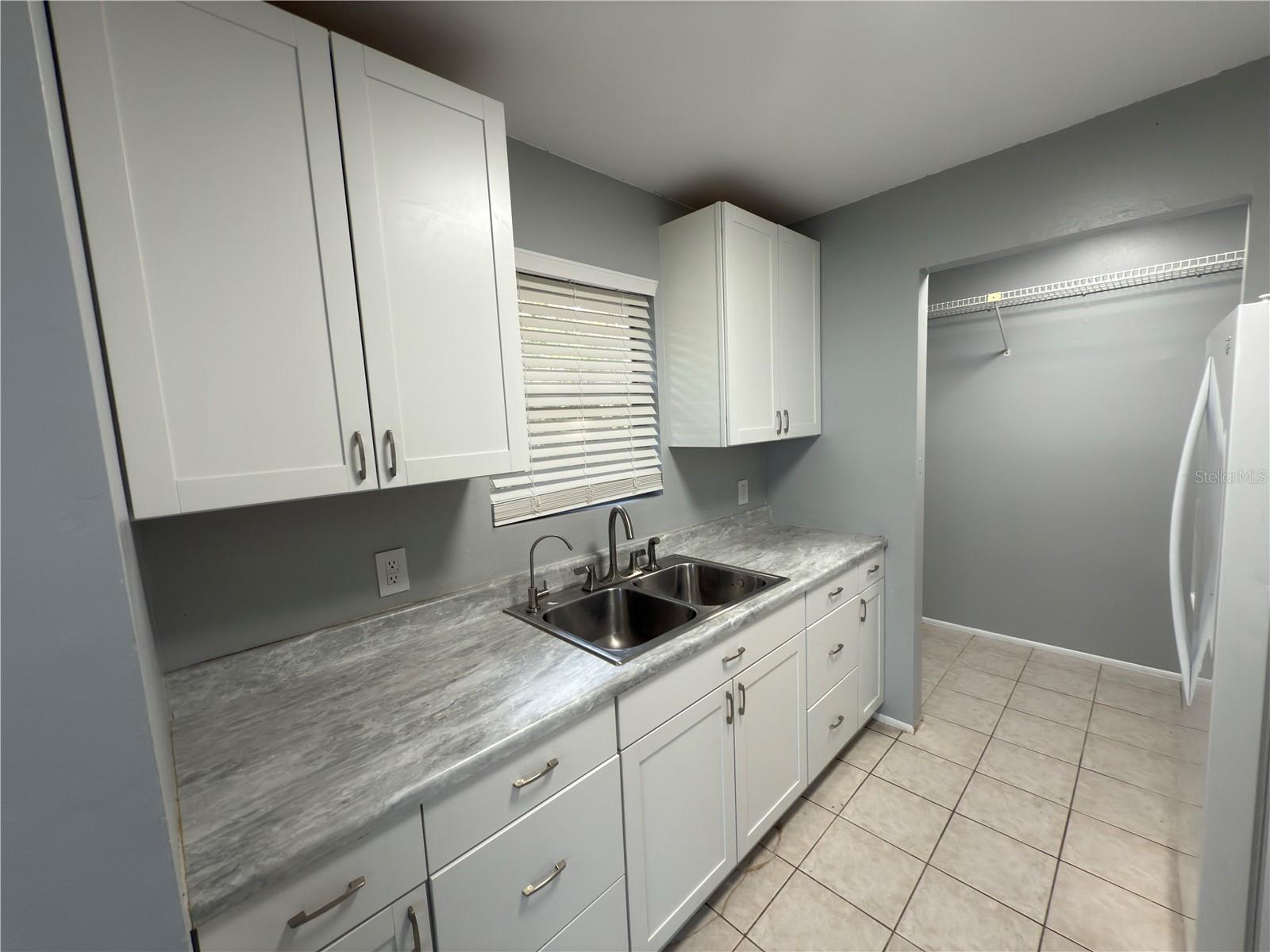 Unit B kitchen with adjacent laundry room