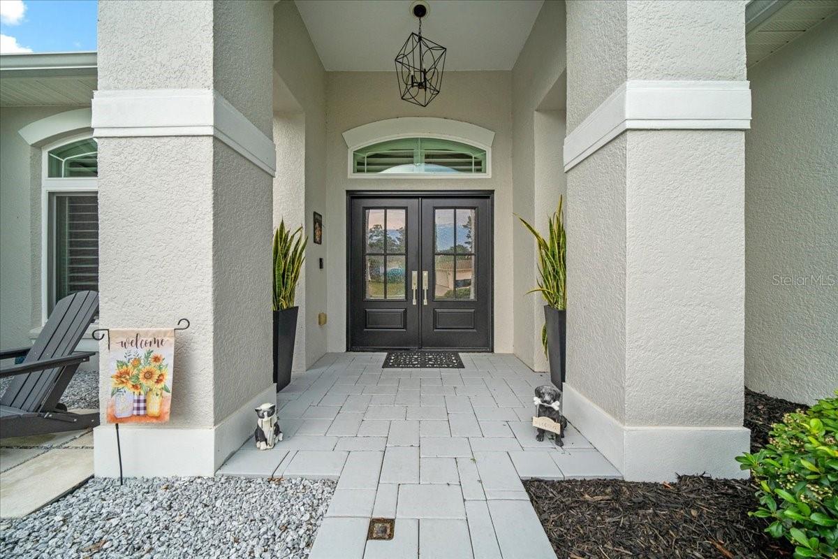 Elegant double doors with covered entry