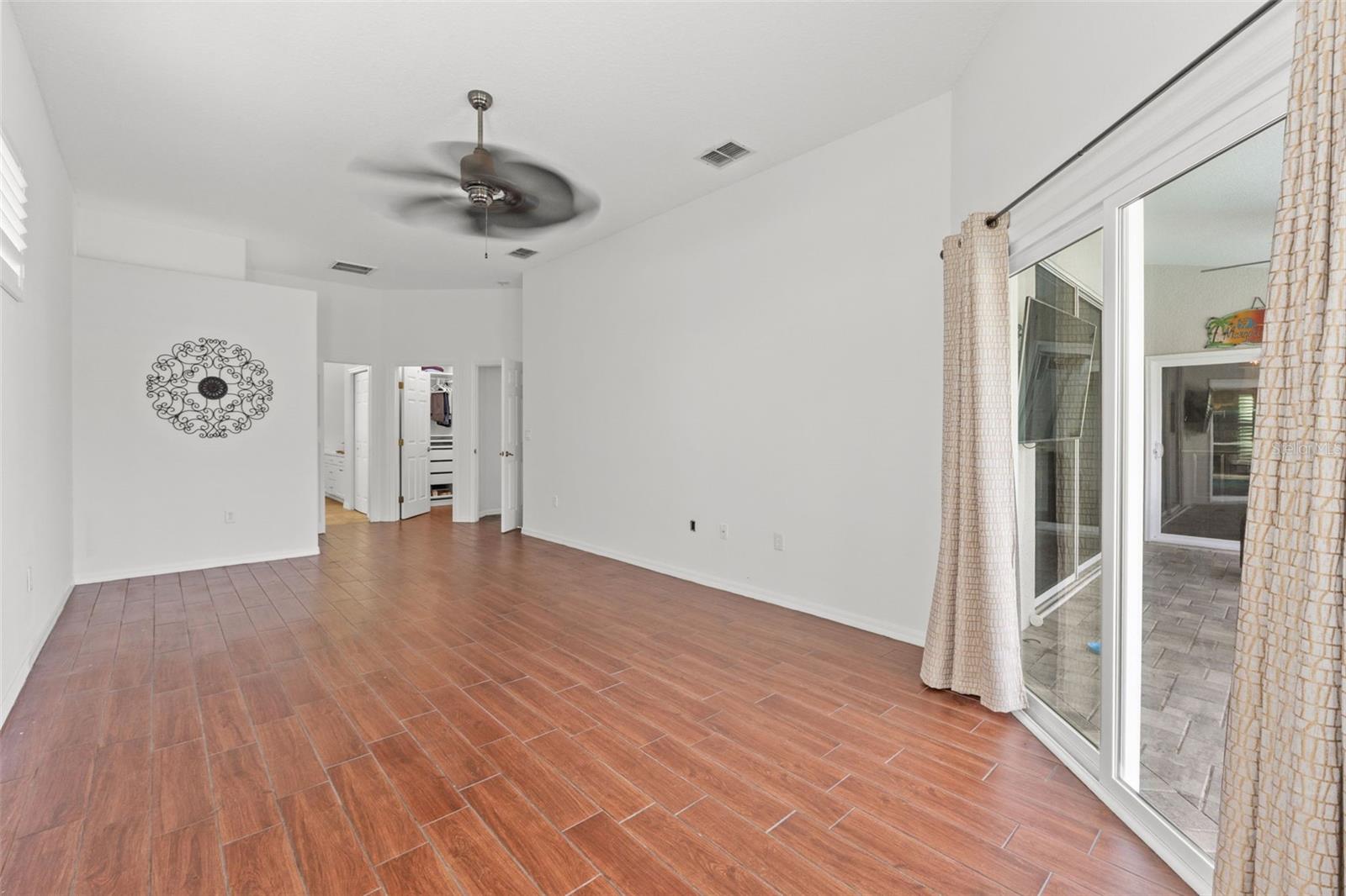 Expansive primary suite with calm, neutral finishes