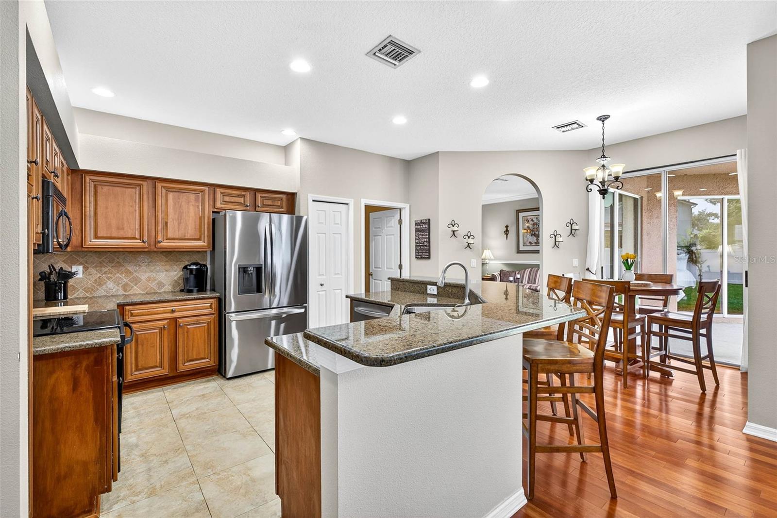 Granite counters, wood cabinetry and stainless appliances