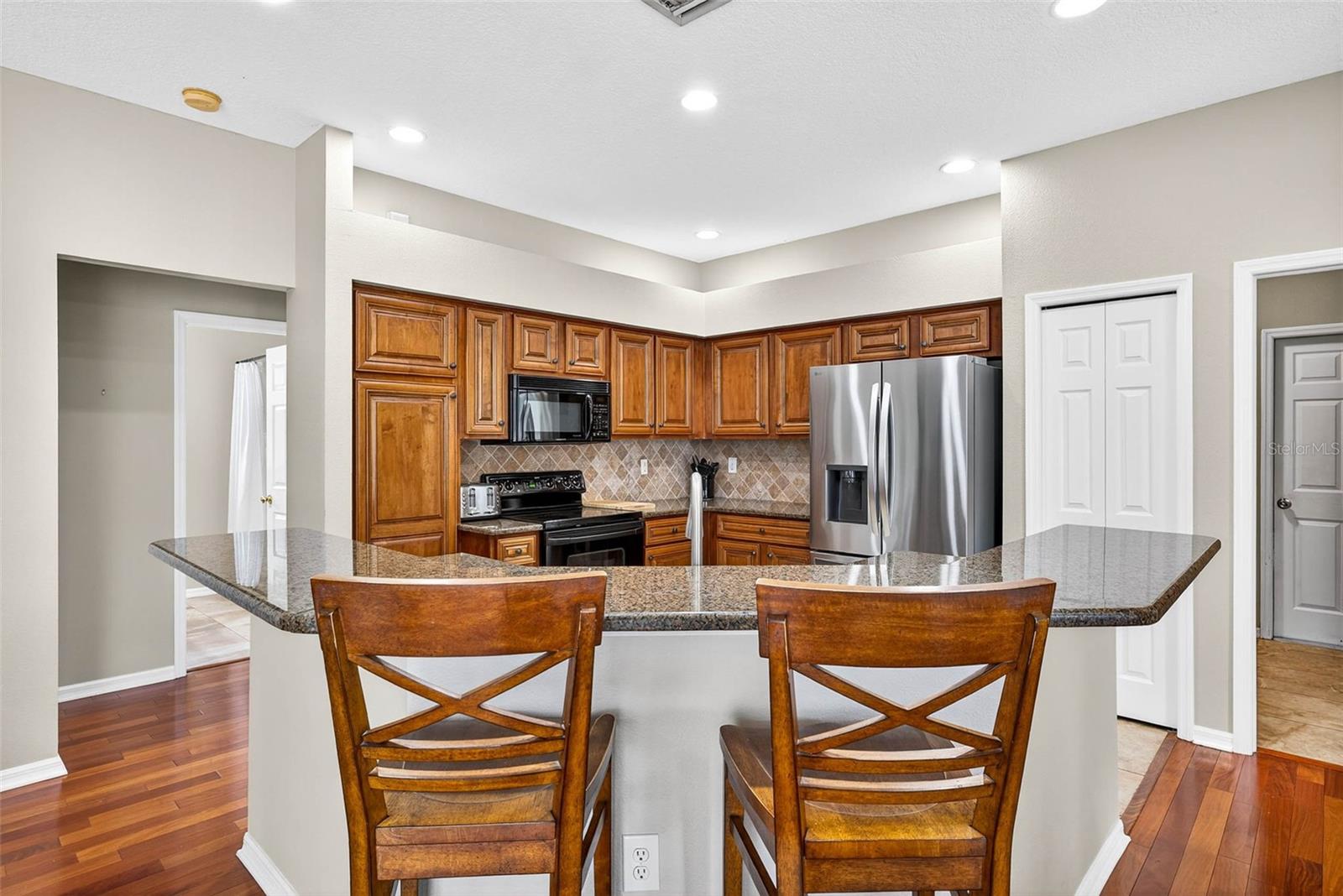 Granite counters, wood cabinetry and stainless appliances